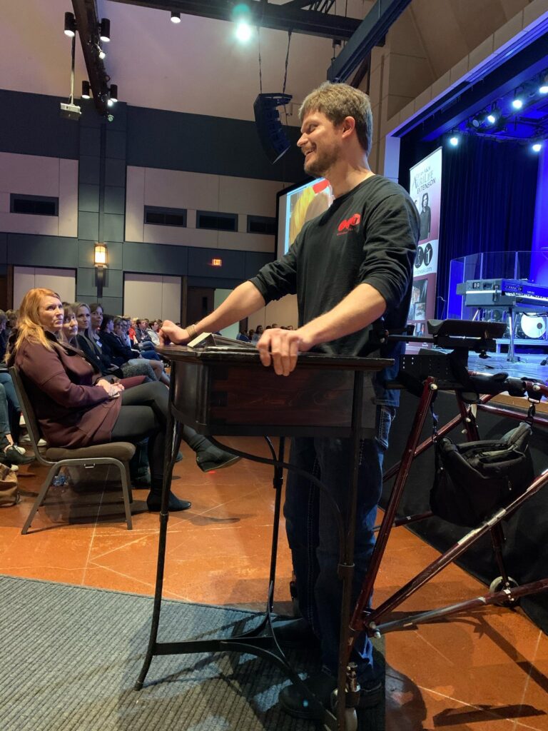 Sean Carter speaking at a church event using his communication device